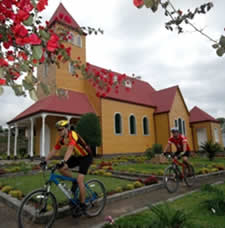Bicylists next to Costa Rican church.