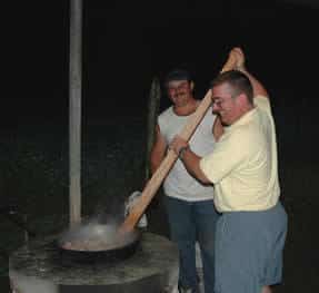 Scott takes a turn at stirring the chicharrones for a tico party.