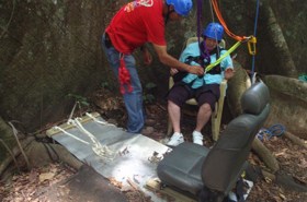 Disabled woman getting ready to ascend to tree platform in Costa Rica rainforest