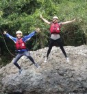 two happy people jump from a rock into the river on a personalized family vacation in costa rica