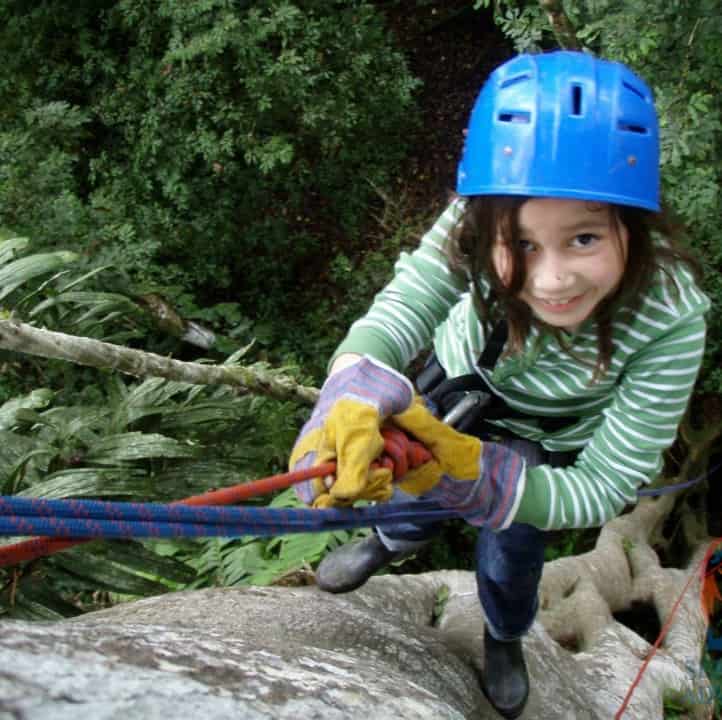 Young girl tree climbing in Costa Rica