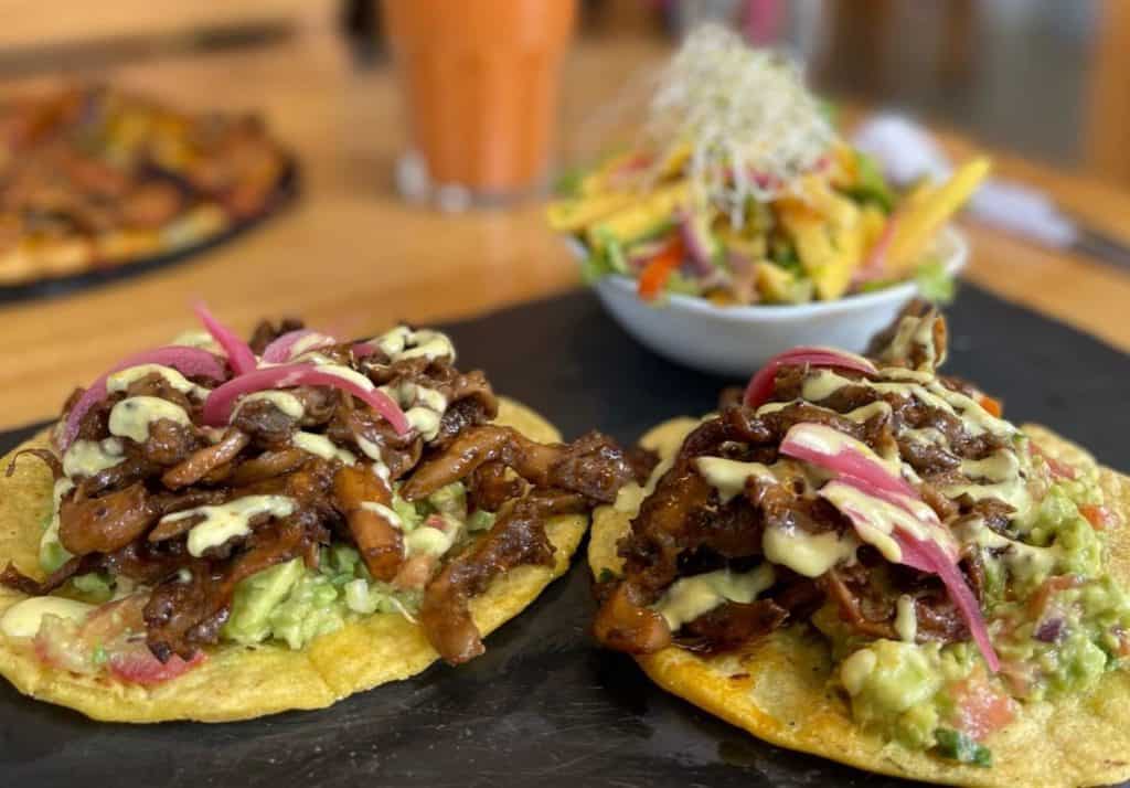 two vegan pulled pork tacos on a slate platter at Arbol de Seda in San José