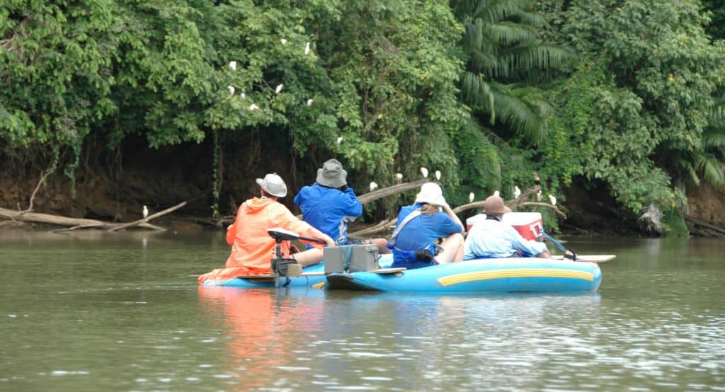 A family and guide on a nature float on a river in Caño Negro Refuge in Costa Rica