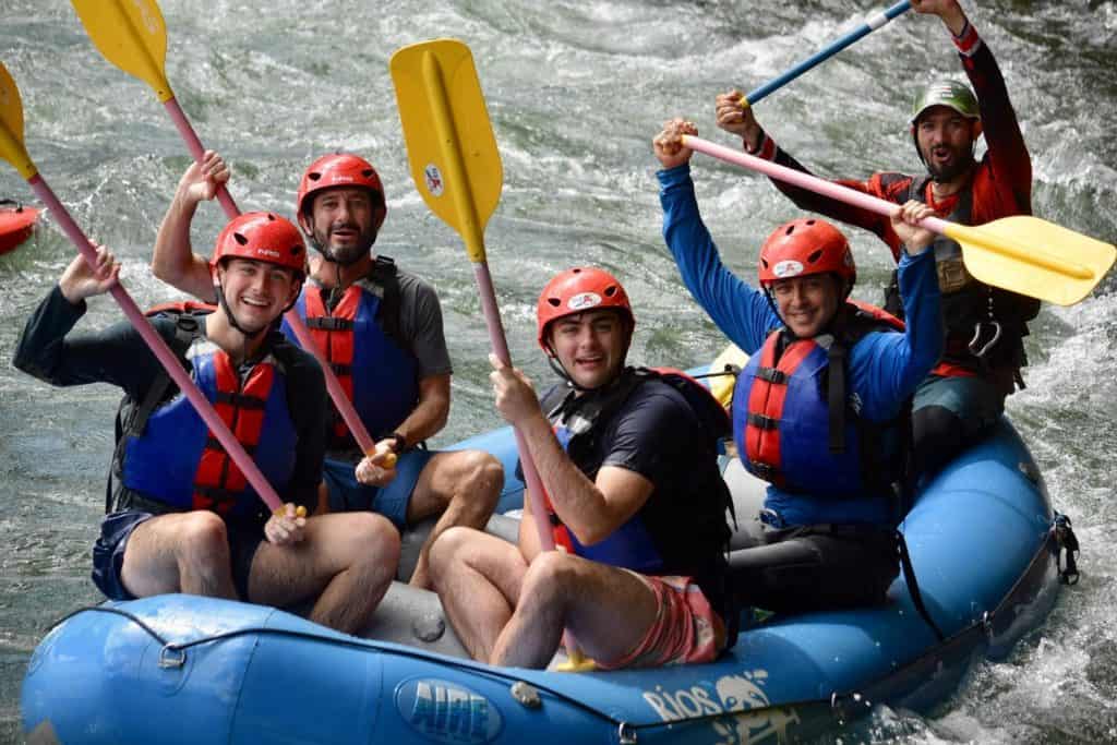 Serendipity Adventure guide Sergio with a father and two sons whitewater rafting on the Sarapiqui River in Costa Rica
