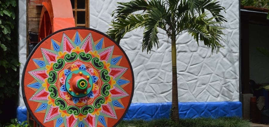 a brightly colored oxcart wheel outside a workshop in the artisan town of Sarchi in costa rica