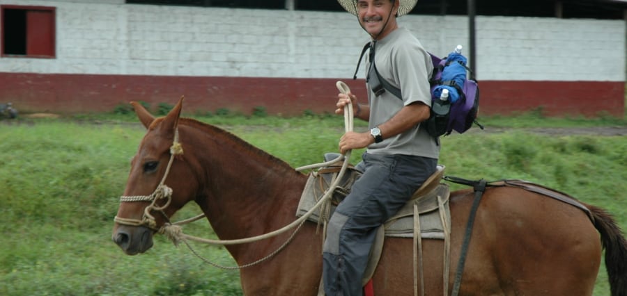 a man horseback riding in Costa Rica on a teambuilding retreat