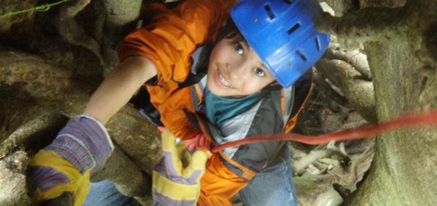 a child tree climbing on a multigenerational family vacation in Costa Rica