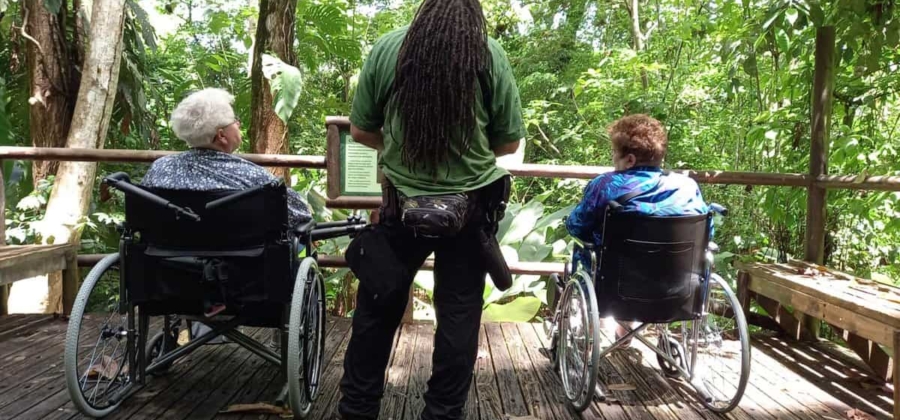 two women in wheelchairs visiting the accessible trails at Carara National Park in Costa Rica