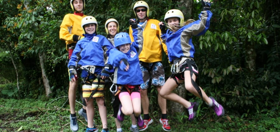 a family enjoying a canyoning adventure during their custom made vacation in Costa Rica
