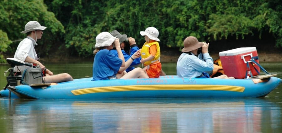 a multigeneration family on a nature safari float on a river in Costa Rica