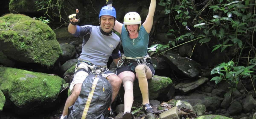 a traveler with leg prosthetics on an accessible canyoning adventure in Costa Rica