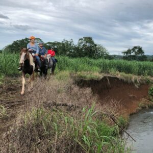 Father and daughter horseback riding in Costa Rica