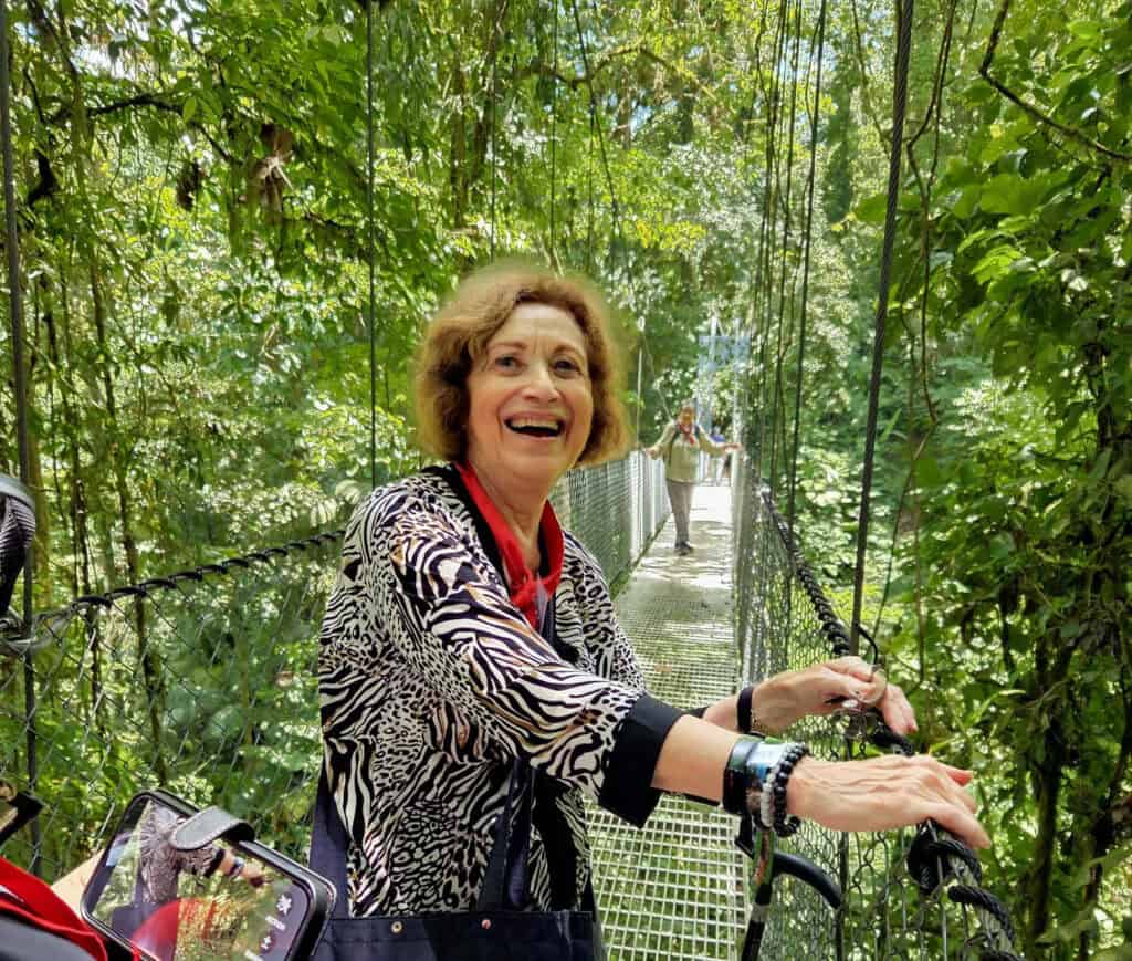 A senior woman laughing on the Mistico Hanging Bridges in Costa Rica