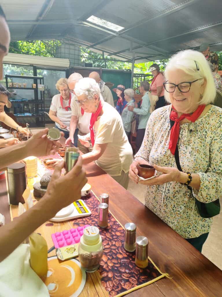 A group of senior travelers enjoying chocolate samples during the Best Chocolate Tour in Sarapiqui, Costa Rica