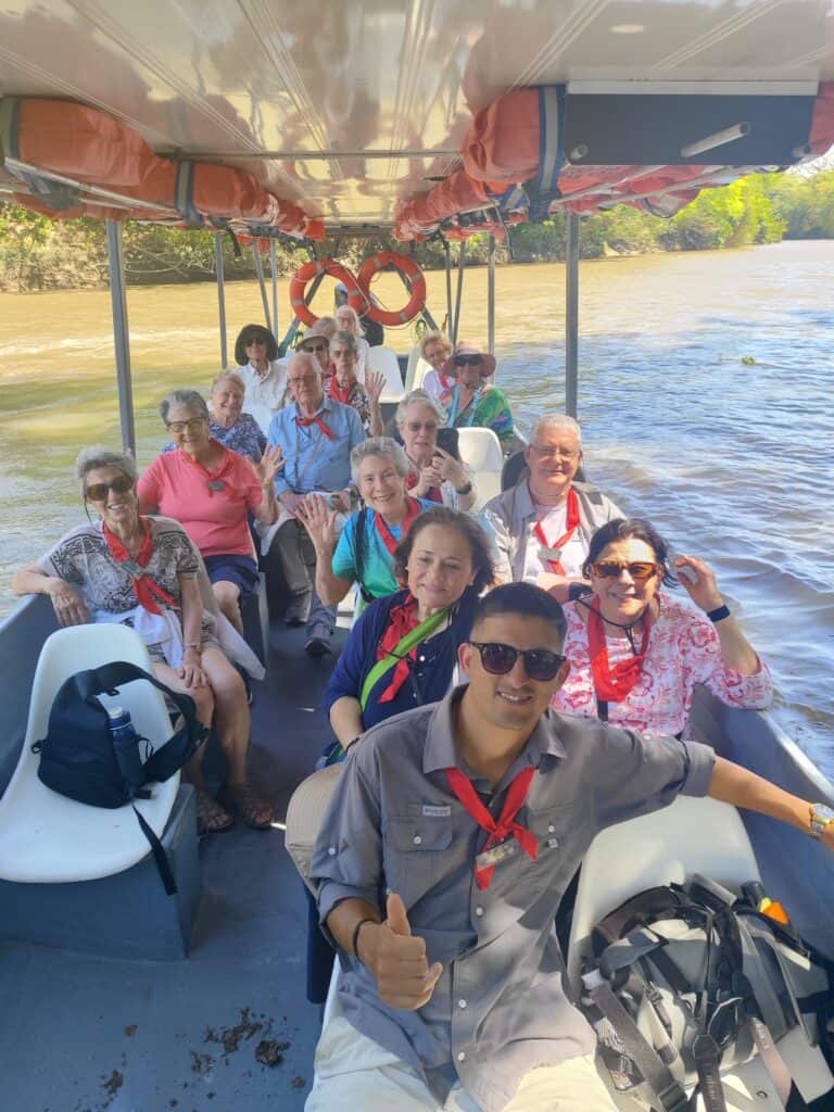 A Serendipity Adventures guide with a group of senior travelers on a boat tour of Hacienda El Viejo Wetlands