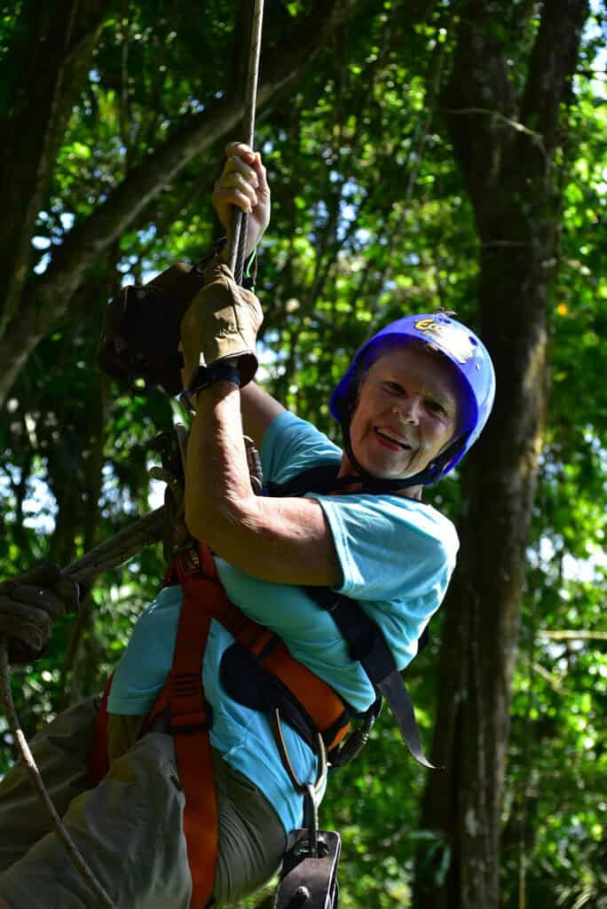 A senior woman on a tarzan swing during a zipline tour in Costa Rica