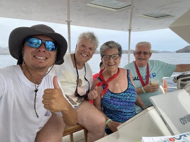 Three senior travelers with a guide from Marlin del Rey during a catamaran tour in Costa Rica