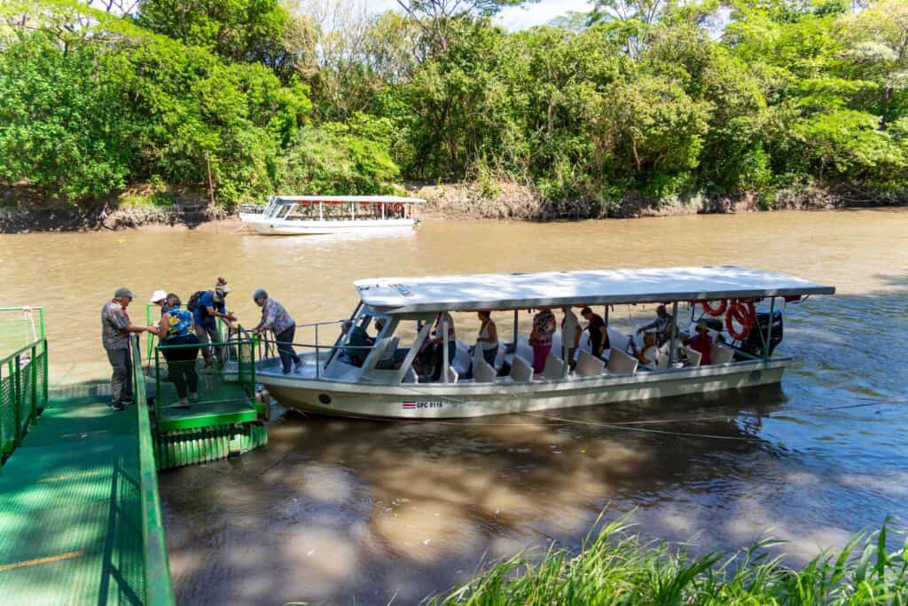 A group of senior travelers leaving a boat in the Hacienda El Viejo wetlands