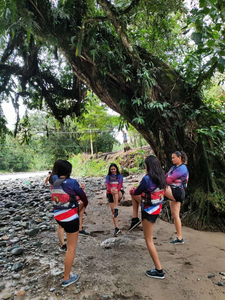 Chicas del Pacuare female rafting team stretching before a practice session on the Pejibaye river in Turrialba